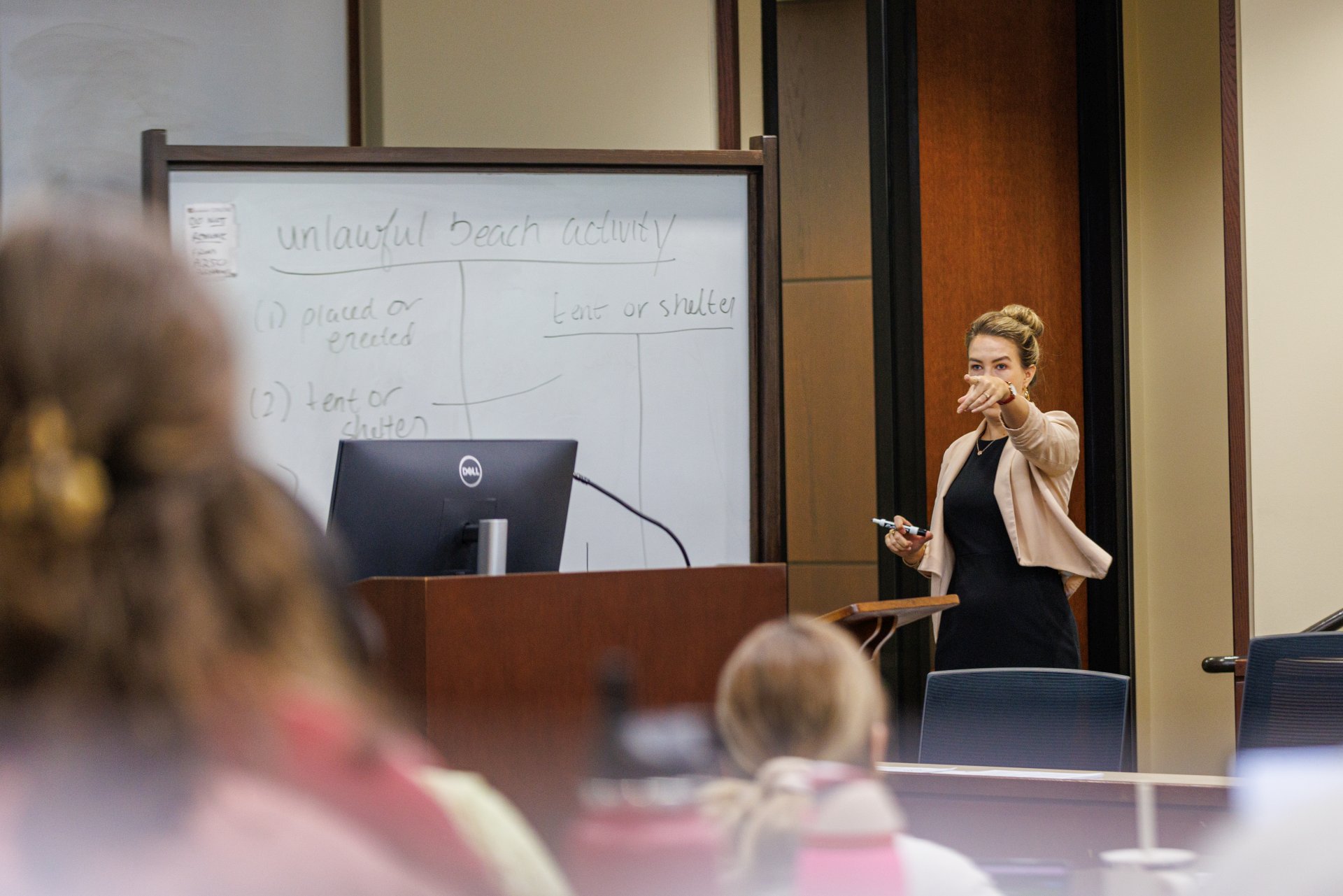 Professor pointing at student to answer a question