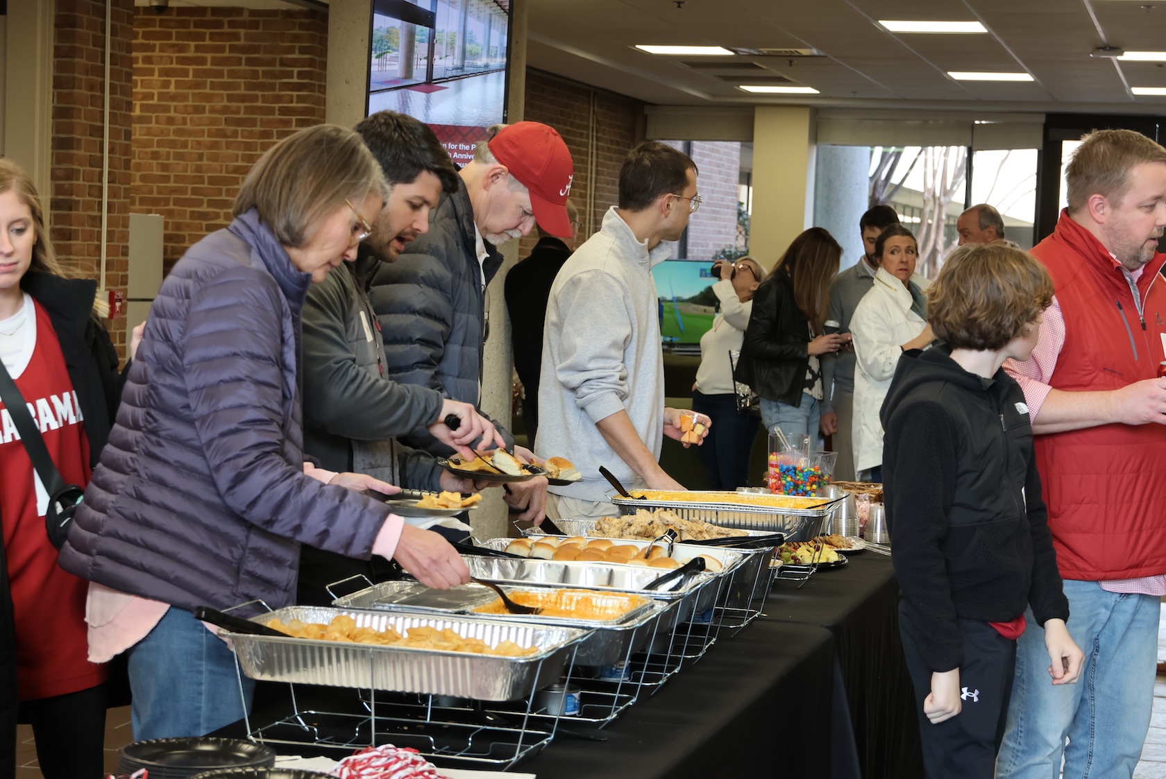 Photo of people getting food from a buffet 