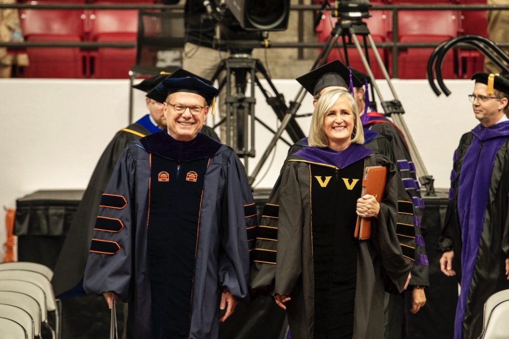 Alabama Supreme Court Chief Justice Stewart and Dean Brewbaker walk side by side as the lead the precessional at commencement.