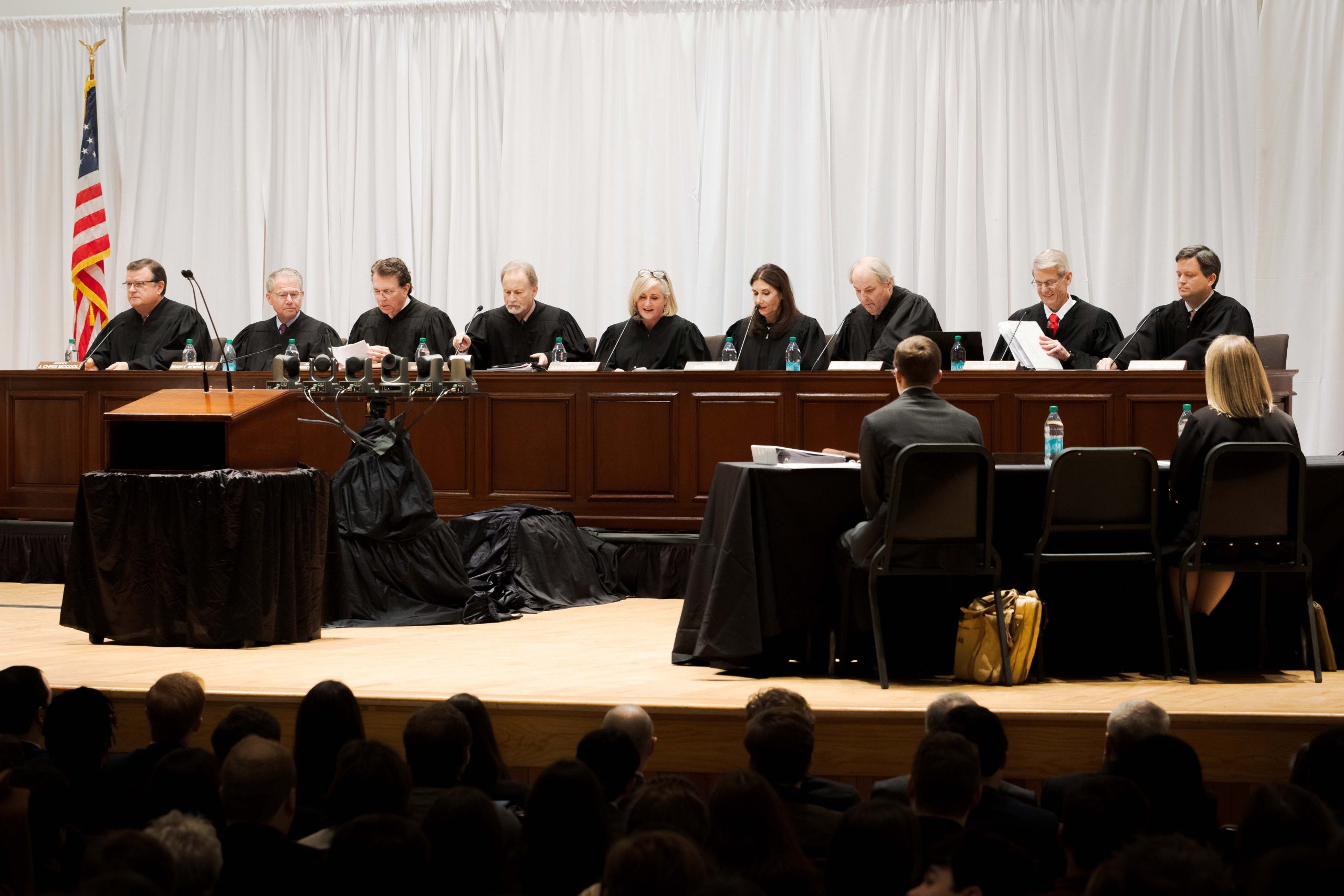 Justice Chris McCool (‘93), Justice Brady E. Mendheim Jr., Justice Tommy Bryan, Justice Greg Shaw, Chief Justice Sarah Stewart, Justice Kelli Wise, Justice William B. Sellers (‘88), Justice Gregory Cook, and Justice Will Parker (‘06) prepare to begin the oral argument hearing in Moody Music Building.