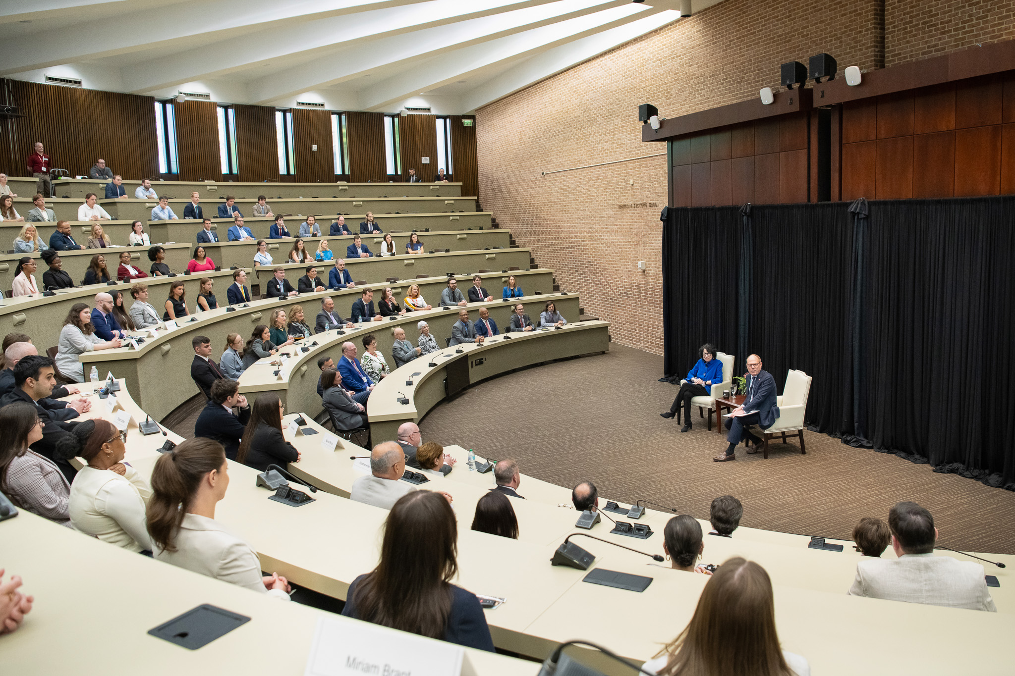 A wide shot of the room, with Justice Sotomayor and Dean Bill Brewbaker seated in chairs in front of an audience in a large lecture hall at The University of Alabama School of Law. 