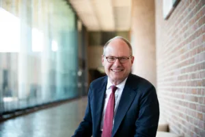 Dean William S. Brewbaker III poses at the entrance of The University of Alabama School of Law.