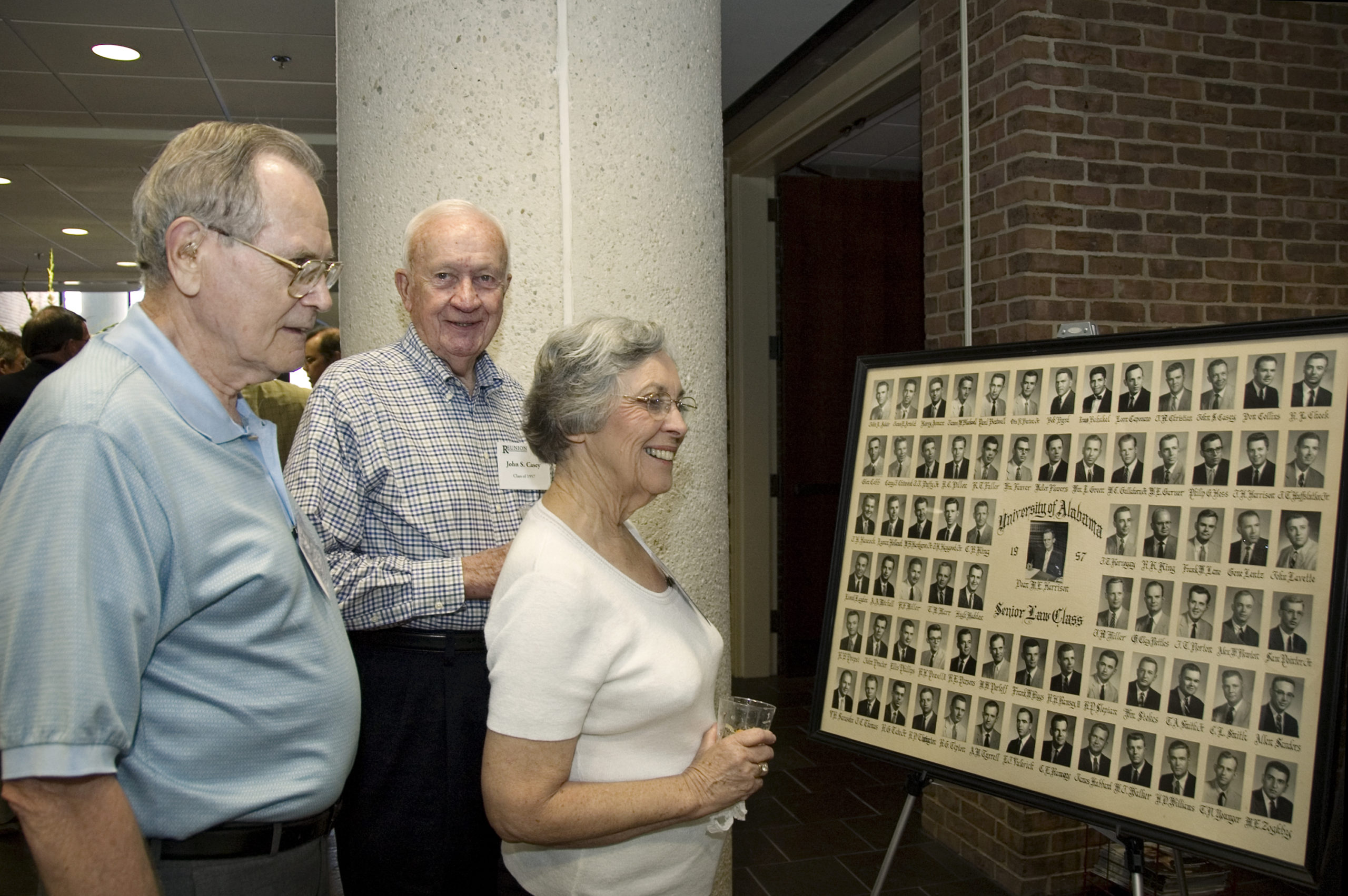 A photo of Alumni looking at Alabama Law Class Composites