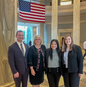 Austin Bowling, Natalie Walls, and Loren Reese pose with Justice Sarah Hicks Stewart