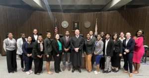 A photo of the Summer Scholars with Judge Sam Junkin.