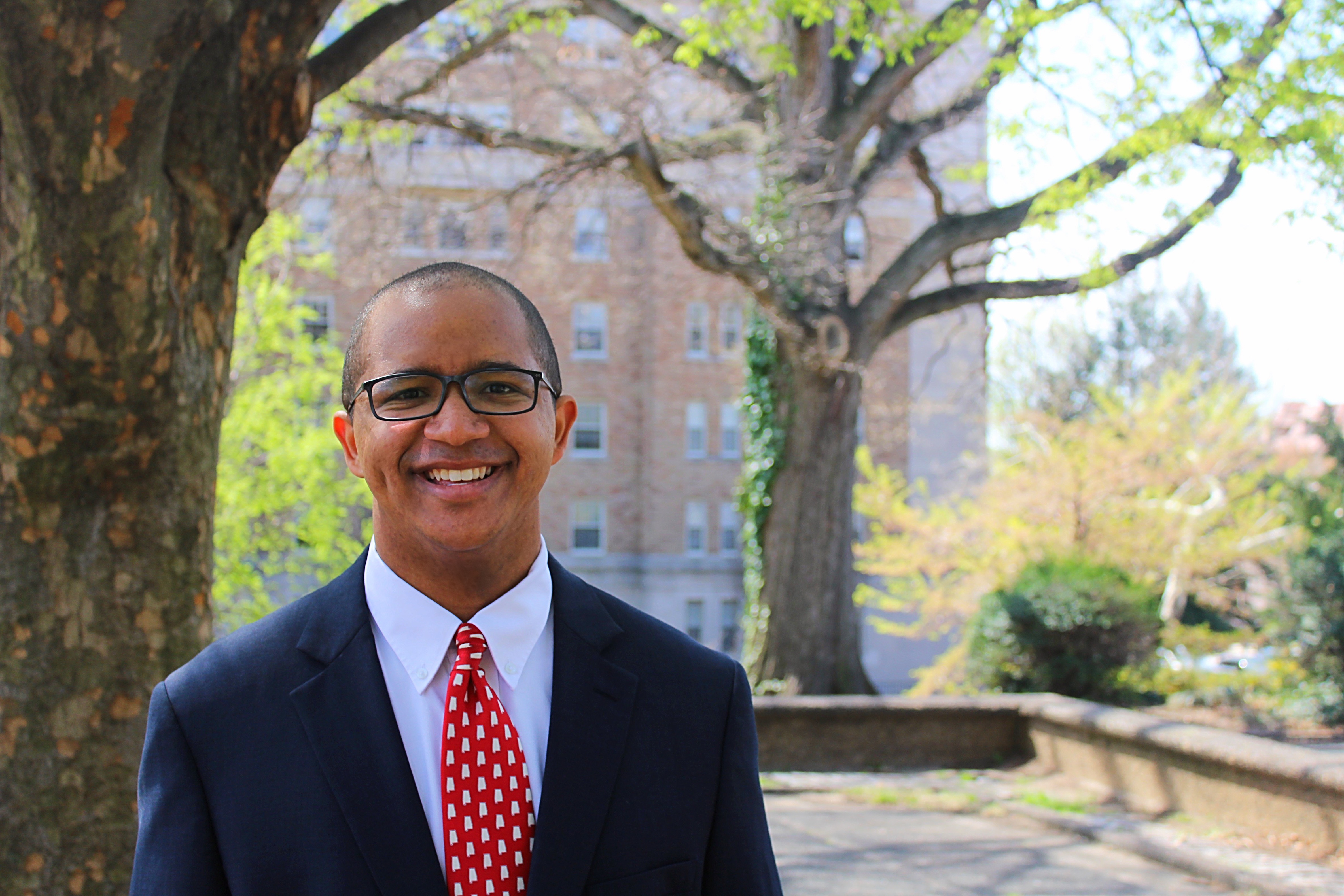 Kyle Campbell standing near a tree