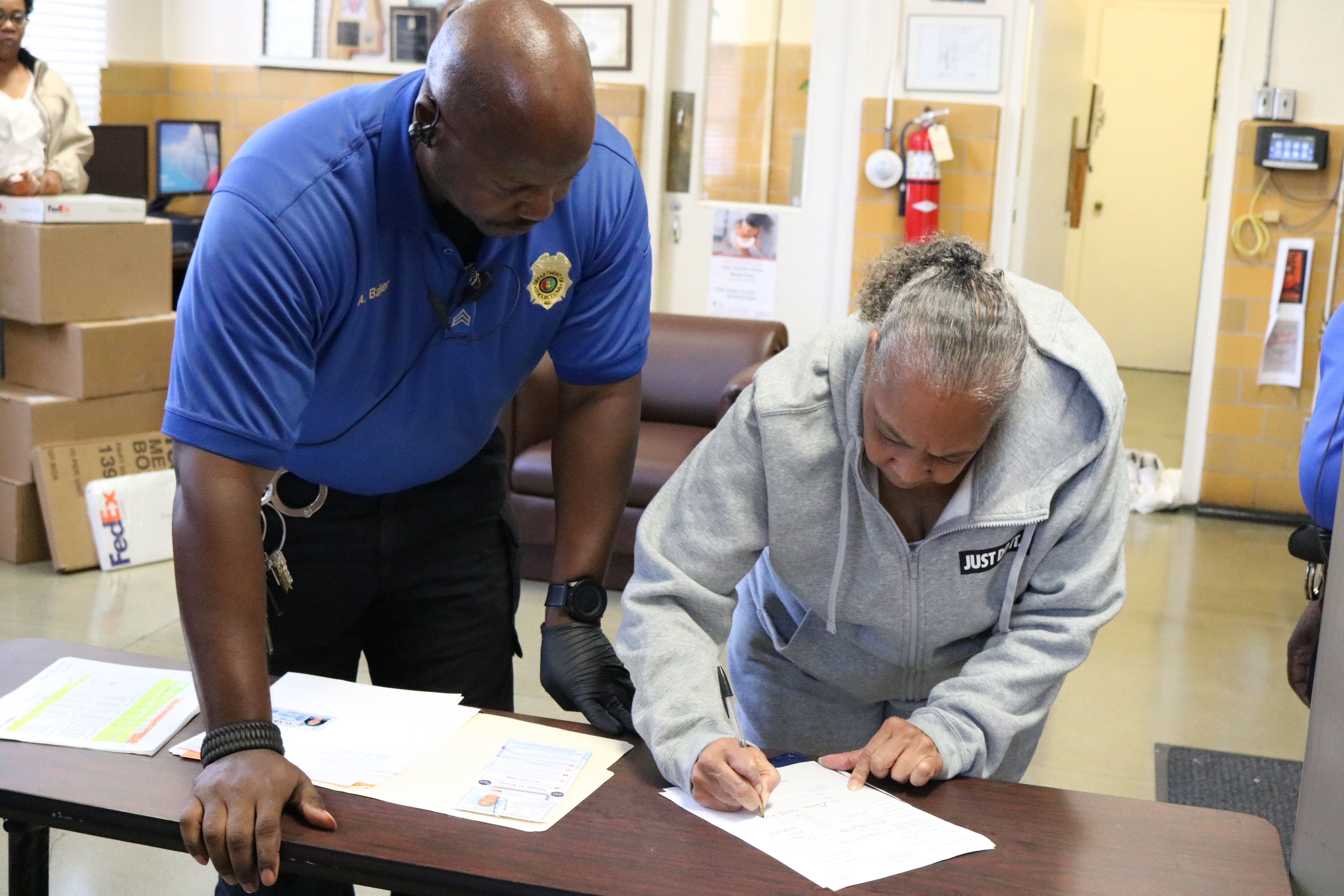 Geneva Cooley signs papers to be released from Julia Tutwiler Prison for Women. 