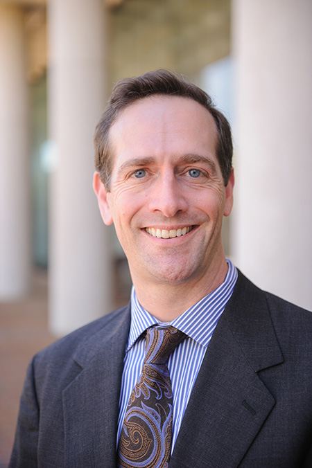 color photograph of Adam Steinman standing outside of the Law School